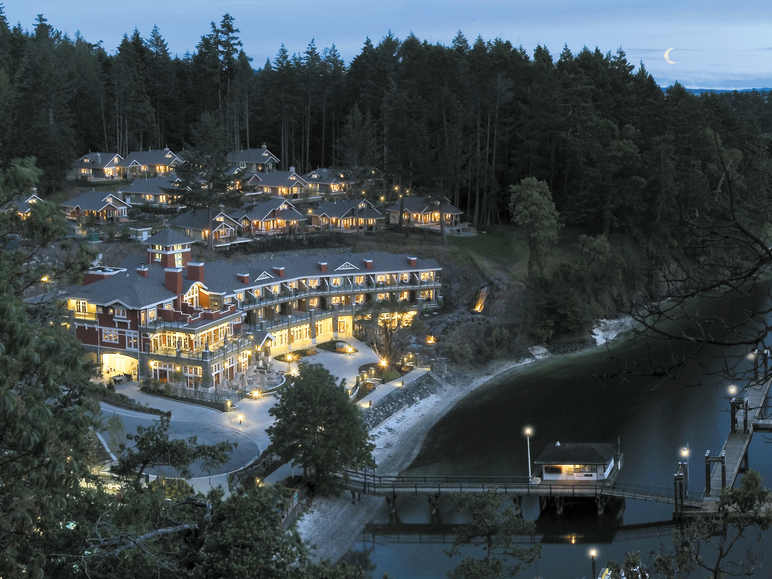 hotel on the water with lights in the early morning