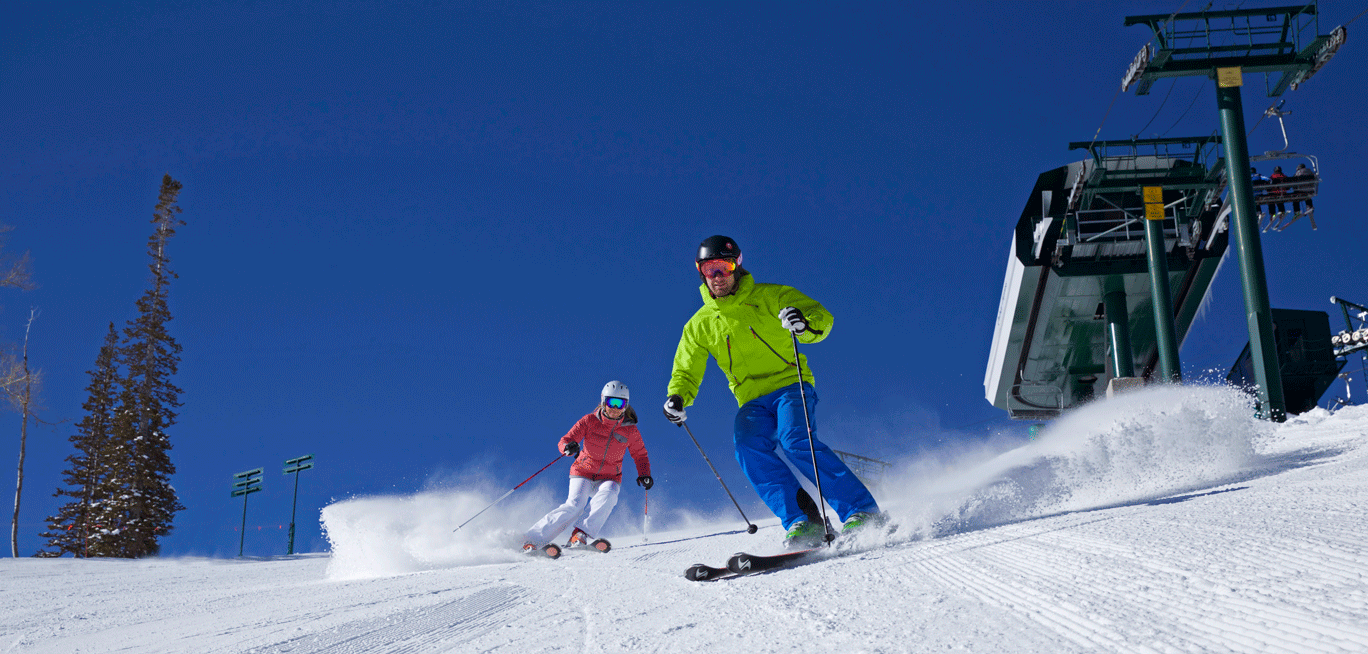 two people skiing down a hill