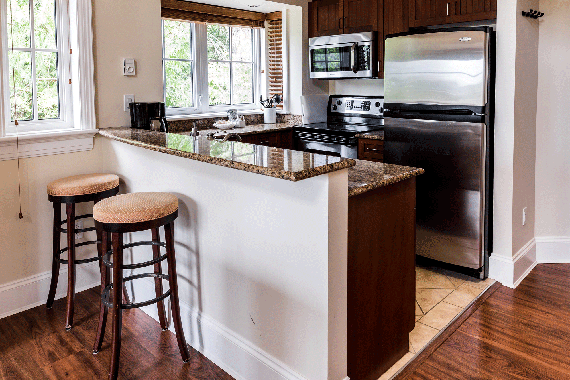 Kitchen with modern appliances in Two-Bedroom Cottage at Poets Cove Resort & Spa