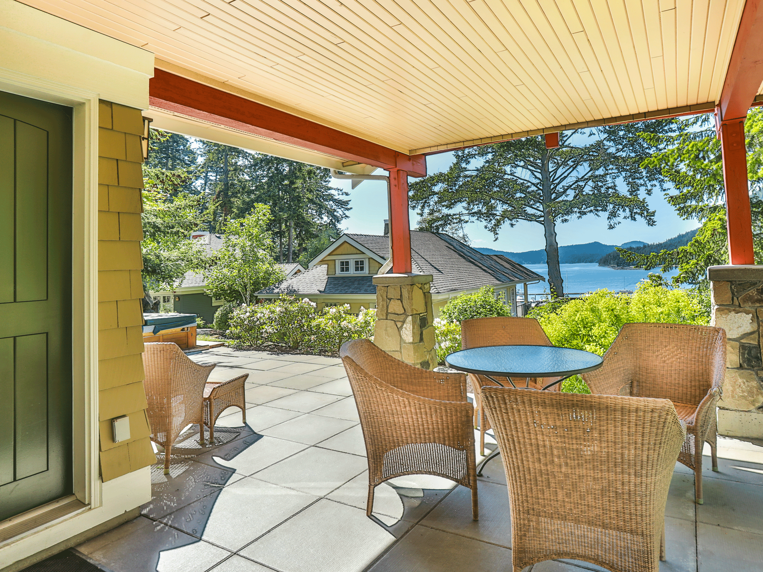 outdoor furniture on patio with water in the background