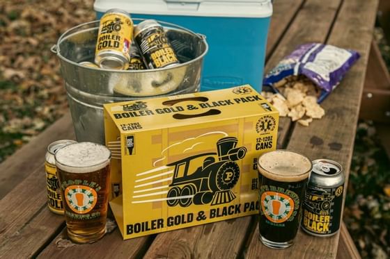 Boiler Gold & Black Pack Beer on a picnic table, Whittaker Inn