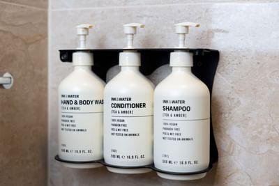A close-up of eco-friendly and vegan bathroom amenities at the Royal on the Park Hotel