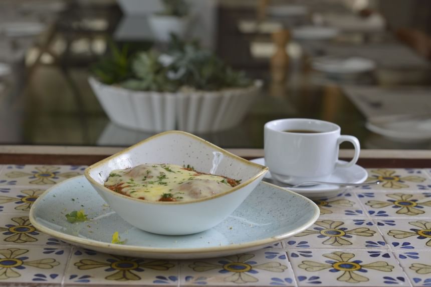 Lasagna served with a cup of tea in The Kitchen at Pensativo House Hotel