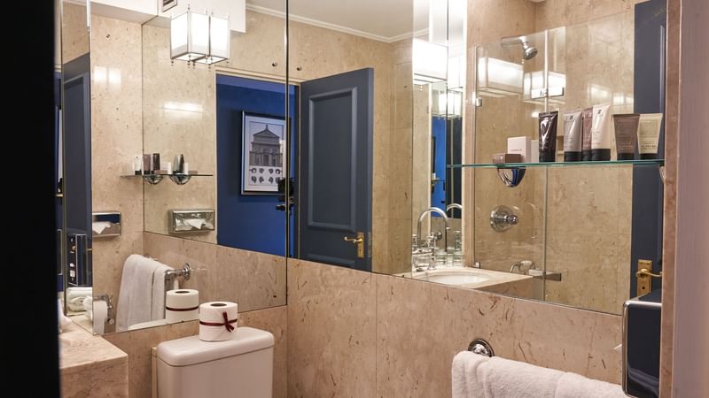 Bathroom with a marbled interior in Classic Room at The Capital Hotel London
