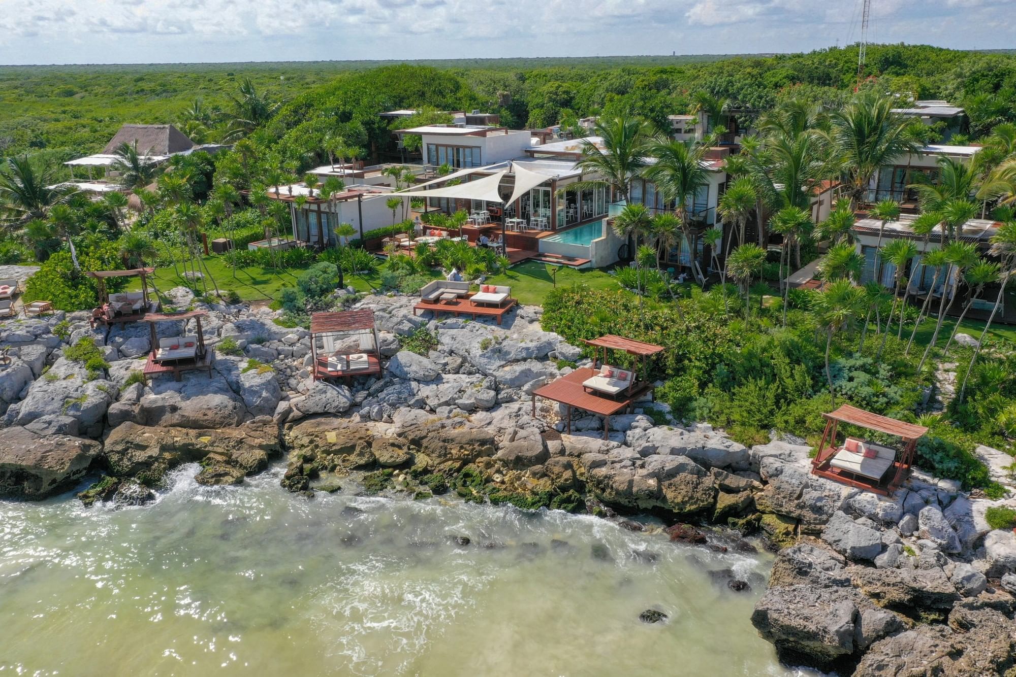 Aerial view of Mi Amor's decks on Tulum's rocky protected coastline