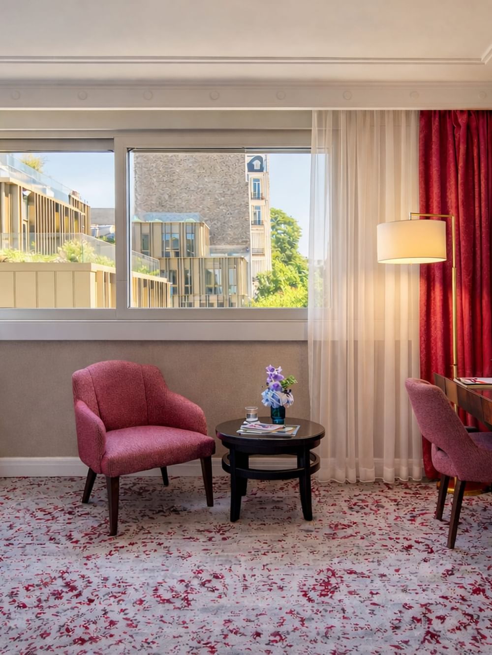  Deluxe Room features Pink armchair by a side table under a floor lamp near large windows at Warwick Paris Champs Elysées