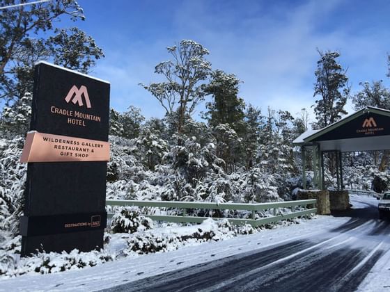 Entrance of the Cradle Mountain Hotel promisers with hotel sign