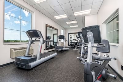 Bright gym with fitness equipment and large windows showing a scenic outdoor view at Off Shore Resort