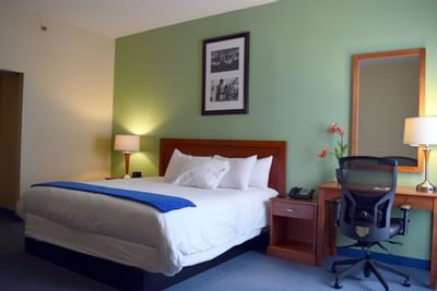 Interior of a room with a king bed at UMass Lowell Inn