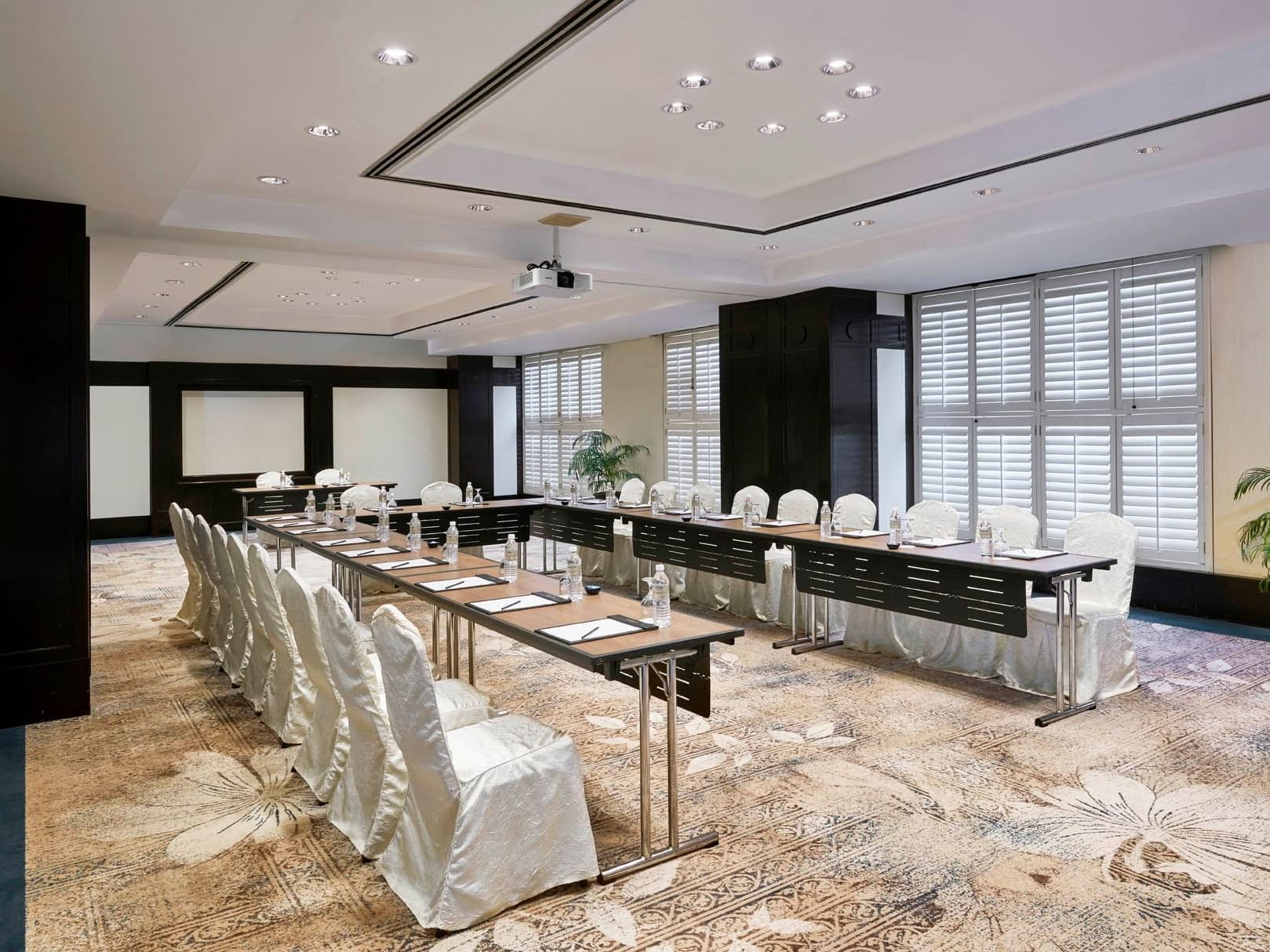Interior of Mutiara meeting room with a U-shaped table arrangement at Saujana Hotel Kuala Lumpur