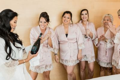 Bride holding a Champagne bottle, The Morgan Resort Spa Village