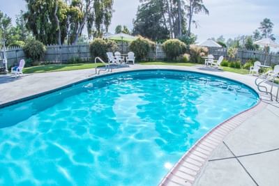 Swimming pool surrounded by lounge chairs