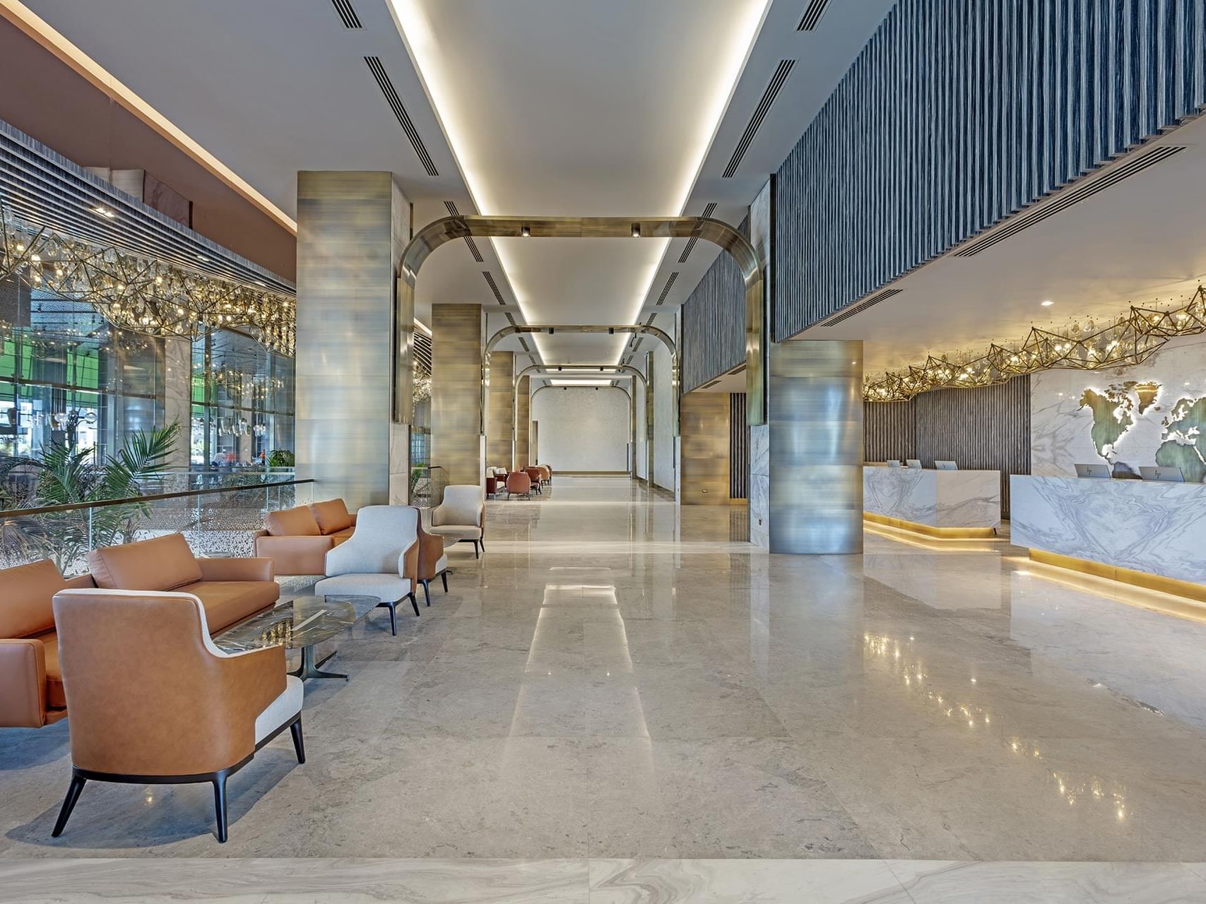 Reception desk by lobby lounge area with marble-tilled floors at Cullinan Belek