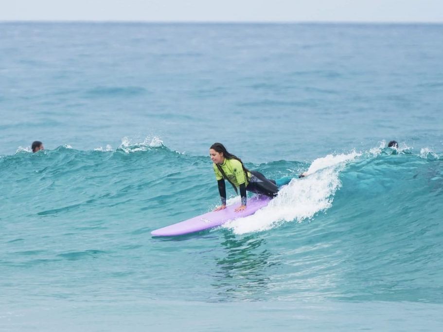 Lady surfing in the beach near Hotel Cascais Miragem