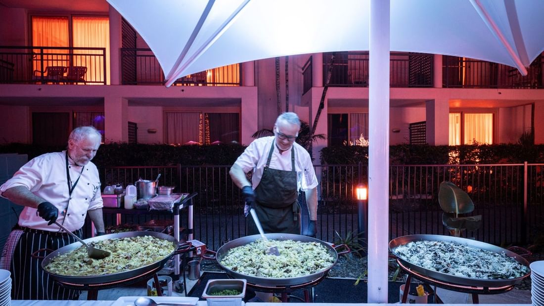 Chefs preparing food on large pans at Mercure Gold Coast Resort in Carrara.