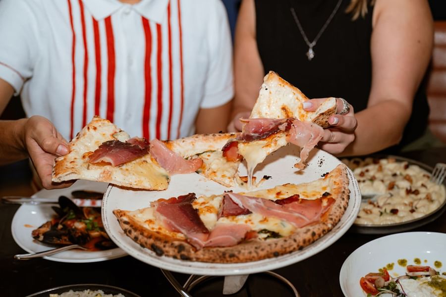 a couple sharing pizza slices
