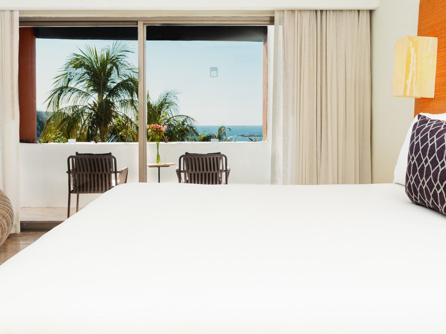 Private balcony seating area with an ocean view in the King Suite at Camino Real Zaashila Huatulco