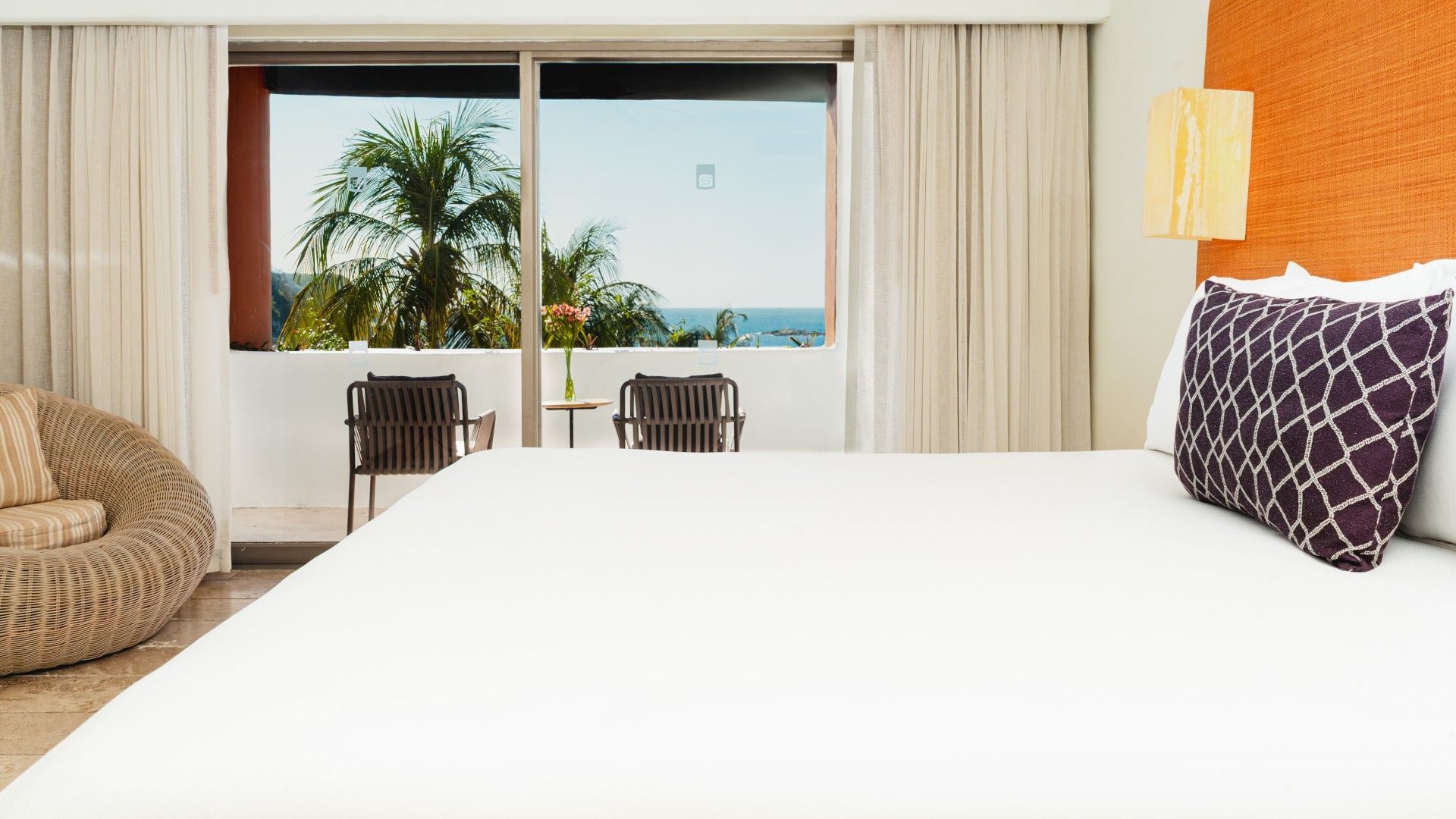 Private balcony seating area with an ocean view in the King Suite at Camino Real Zaashila Huatulco