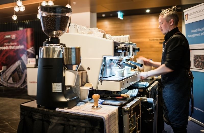 Barista making coffee by the counter at Jasper Hotel