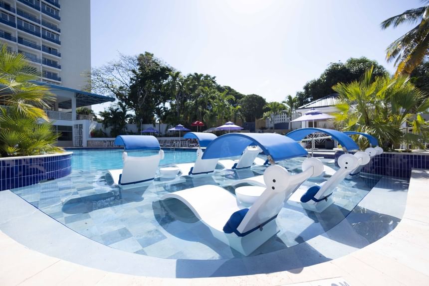 A outdoor pool with sunbeds at Jamaica Pegasus Hotel