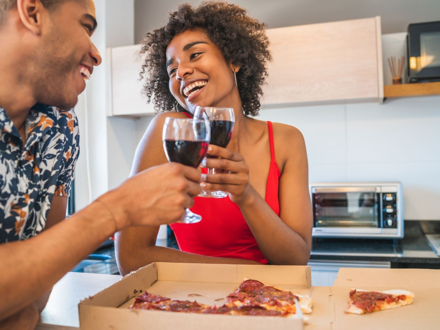 Couple enjoying wine & pizza at Pop Art Hotel Manizales