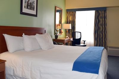 Interior of a room with a king bed at UMass Lowell Inn