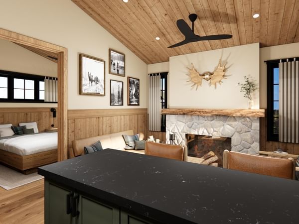 Cabin with fireplace, wood paneling, and separate bedroom.