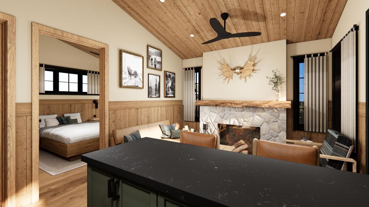 Cabin with fireplace, wood paneling, and separate bedroom.