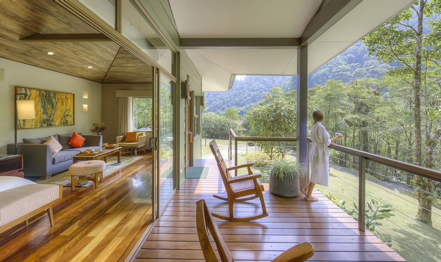 woman enjoying mountain view on balcony