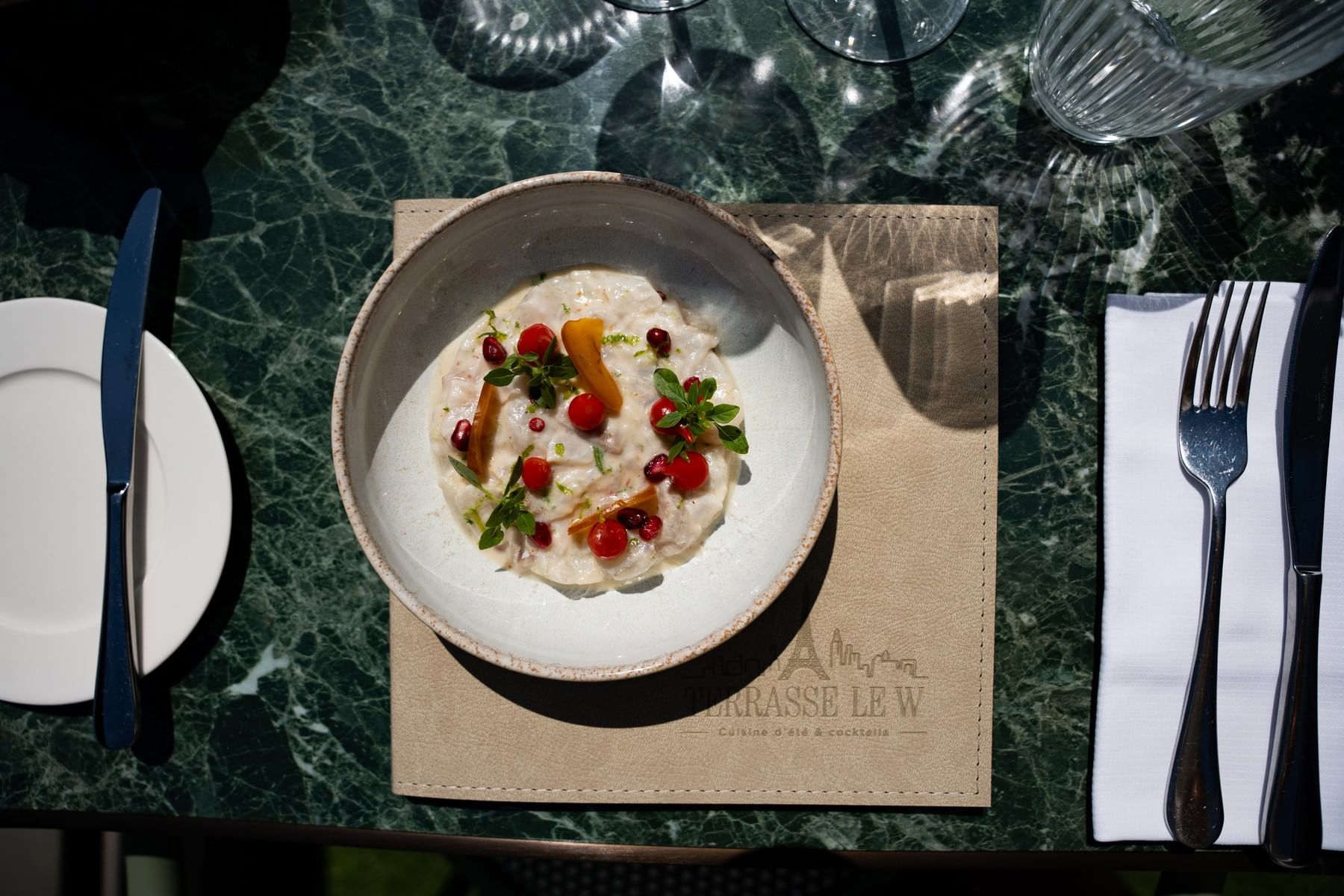 Creamy dish with tomato and herbs on a green marble table at Restaurant, Bar & Terrace Le W, the best Restaurant in Paris