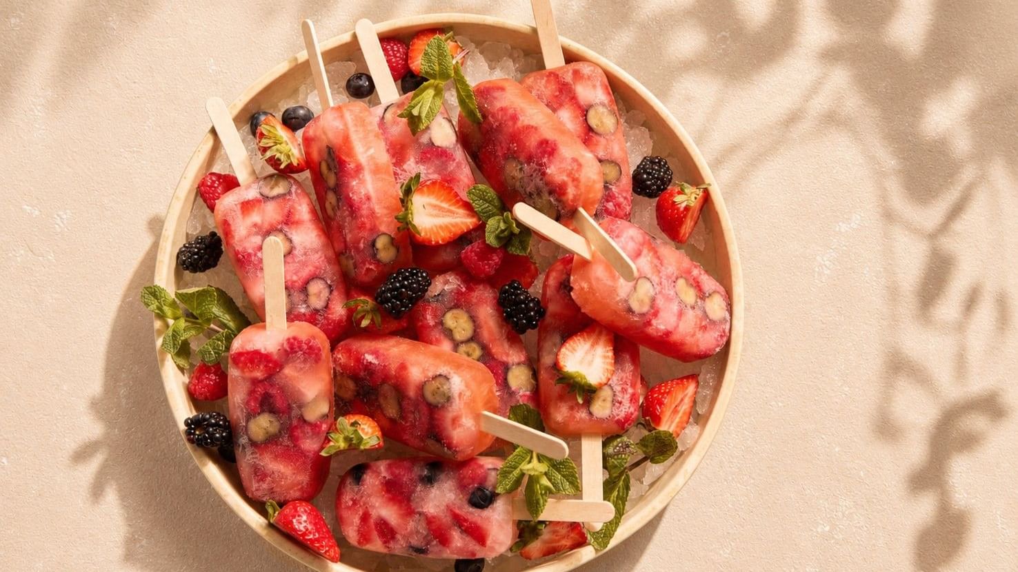 A bowl of fruit ice lollies with mint at The Londoner for Whitcomb's Summer Terrace Menu