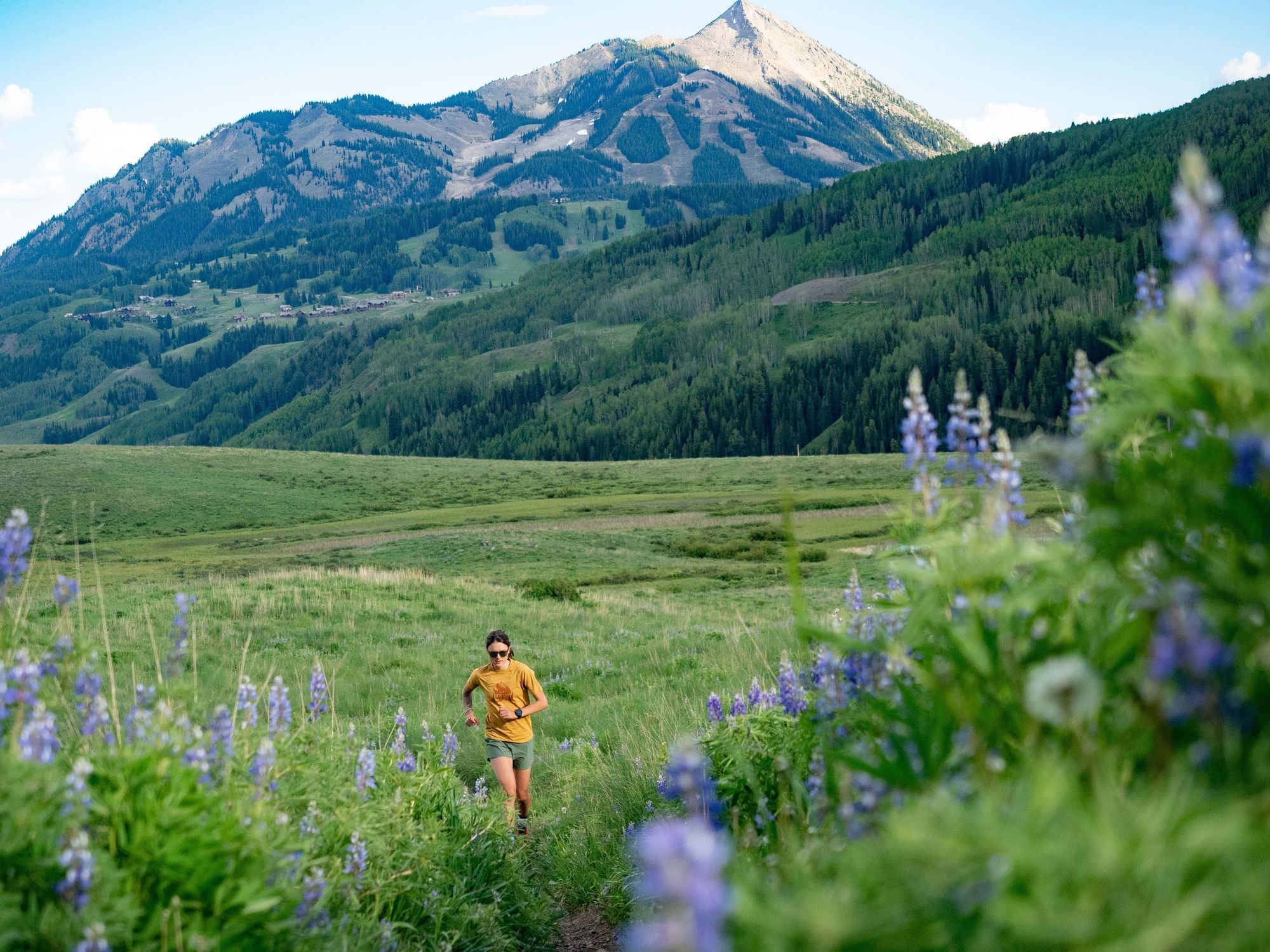 Woman running on a mountain trail at the Elevation Hotel and Resort in Colorado.
