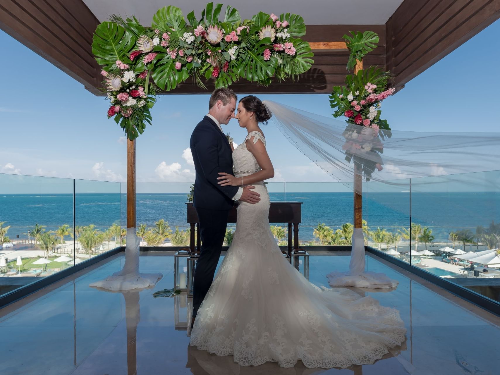 Wedded couple posing for a picture in the wedding venue at Haven Riviera Cancun