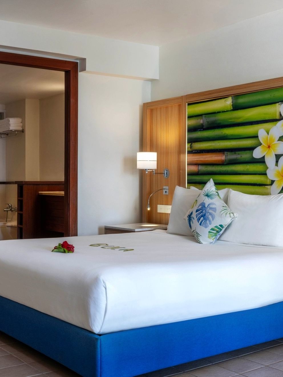 Elegant suite at The Naviti Resort in Korolevu featuring a king bed, tropical decor, and modern amenities.