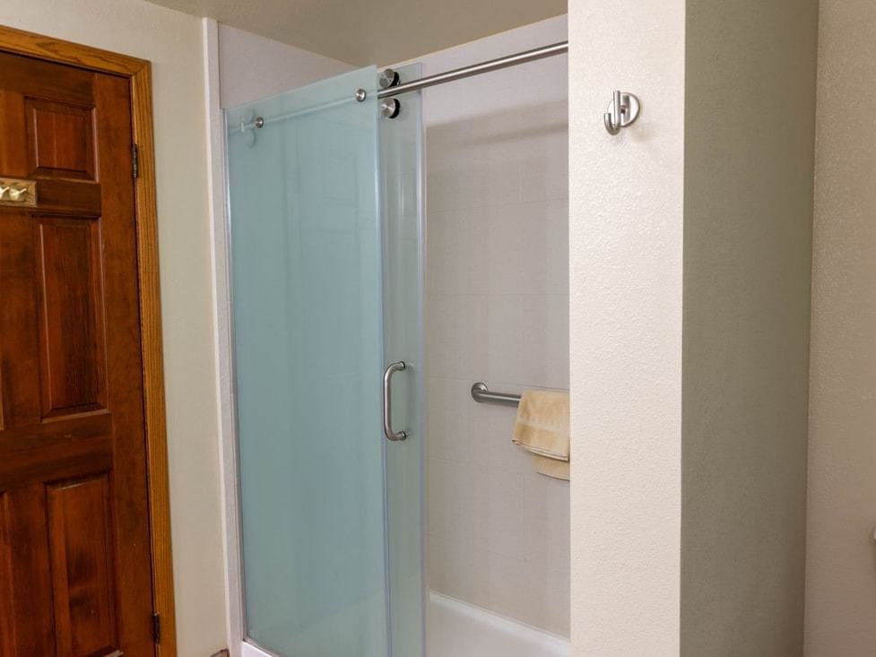 Bathroom featuring a functional shower with a frosted glass door and towel rail in The Cottonwoods at The Ranch at UCross
