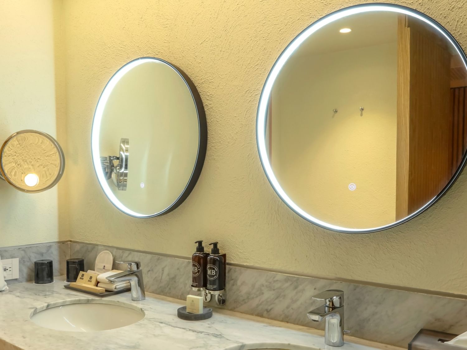 King Superior Junior Suite bathroom with dual sinks and lighted mirrors at Camino Real Polanco Mexico in Ciudad de Mexico.