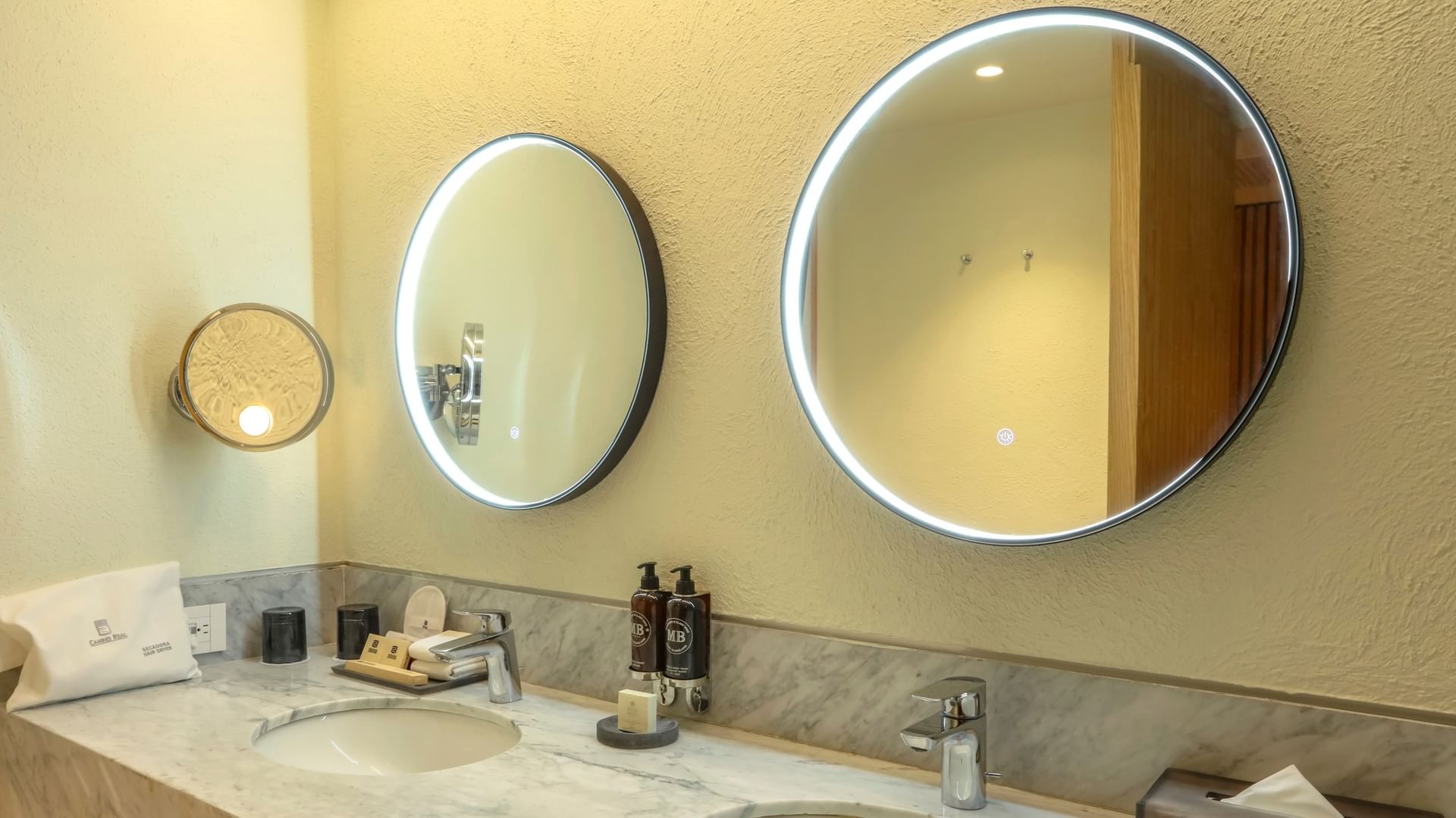King Superior Junior Suite bathroom with dual sinks and lighted mirrors at Camino Real Polanco Mexico in Ciudad de Mexico.