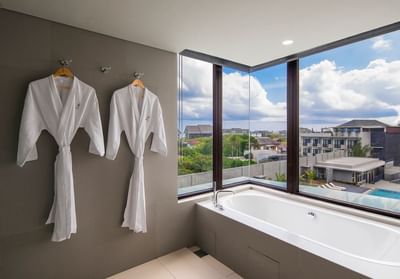 Bathrobes & bathtub in Suite at Eastin Ashta Resort Canggu