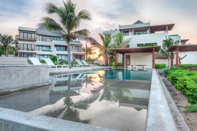 Sunbeds by the outdoor pool at Marea Beachfront Villas