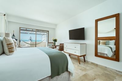 Sophisticated and bright boutique hotel room featuring an elegant king-size bed and modern layout.
