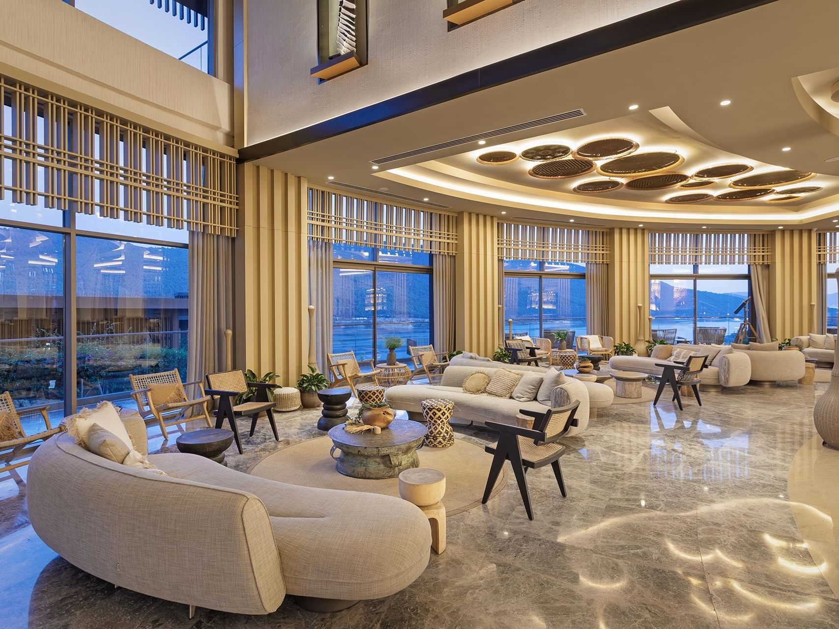 Modern lounge with scenic views at Titanic Luxury Collection Bodrum sleek design, serene ambiance.