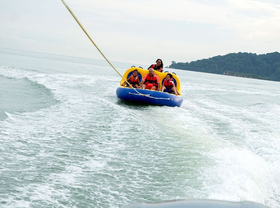 A group of people on the bandwagon water activity - Lexis Hibiscus