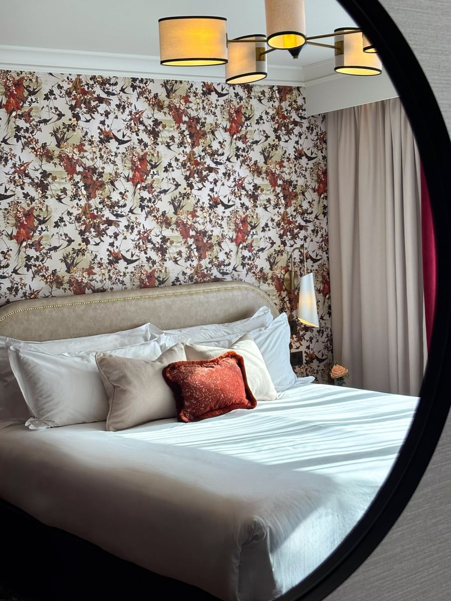 Bed with side tables against the pattern wall in Superior King at The Capital Hotel, Apartments and Townhouse