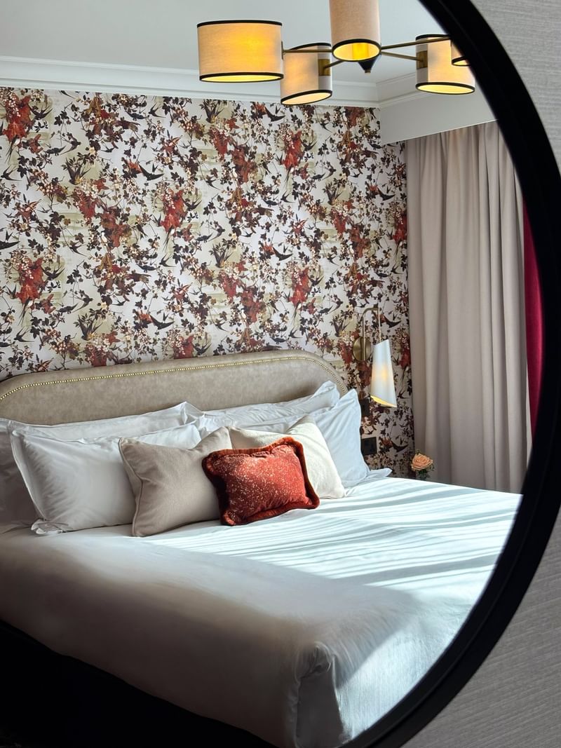 Superior Room with a floral-patterned wall and comfortable bed at The Capital Hotel, Apartments & Townhouse