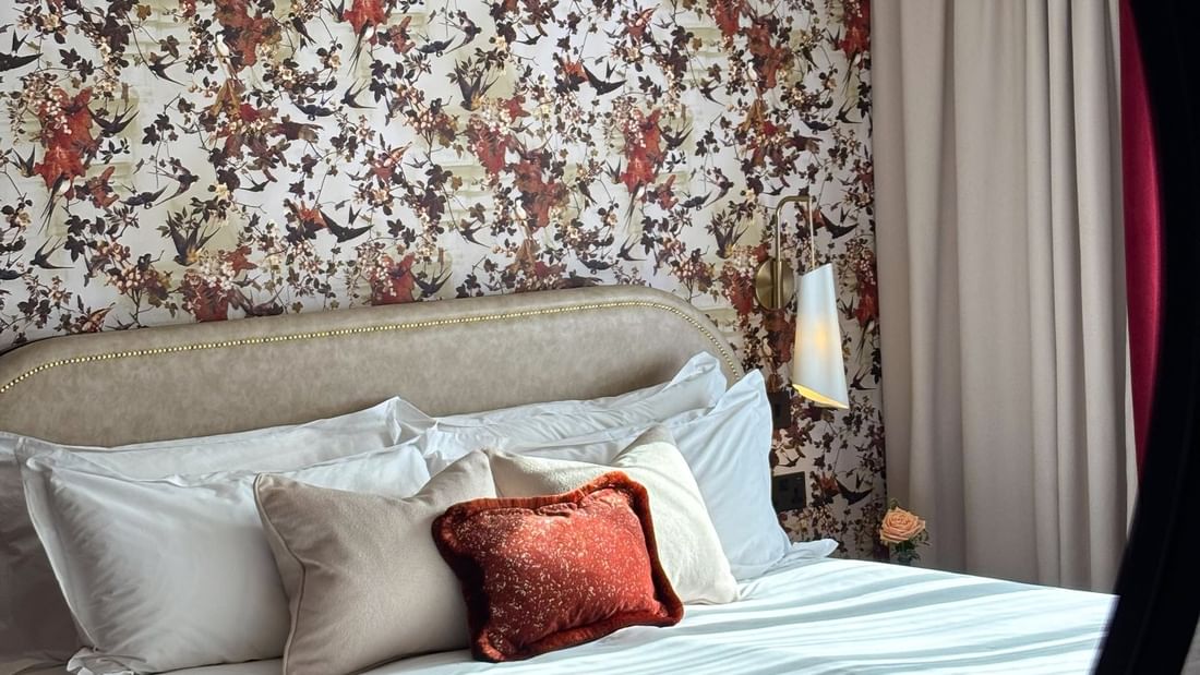 Close-up of bed with plush pillows under table lamp in Superior King / Twin at The Capital Hotel, Apartments and Townhouse