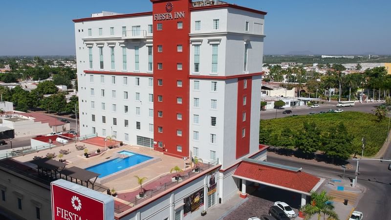 Two cozy double beds with a TV and a work desk at Fiesta Inn Suites Aeropuerto del Bajio