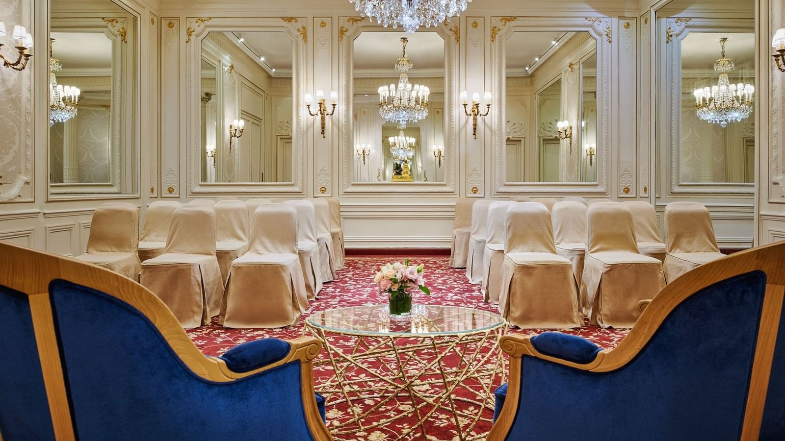 Armchair with a glass coffee table facing the theater set up in Capucines Meeting Room at Hotel Westminster Paris