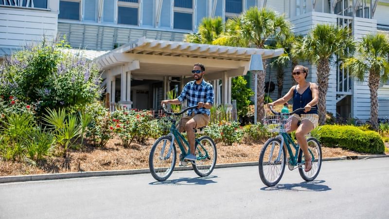 Couple Riding Bikes in front of WaterColor Inn