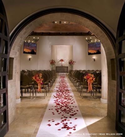 Hilton Santa Fe Buffalo Thunder chapel prepared for a wedding with rose petals along the aisle and elegant seating