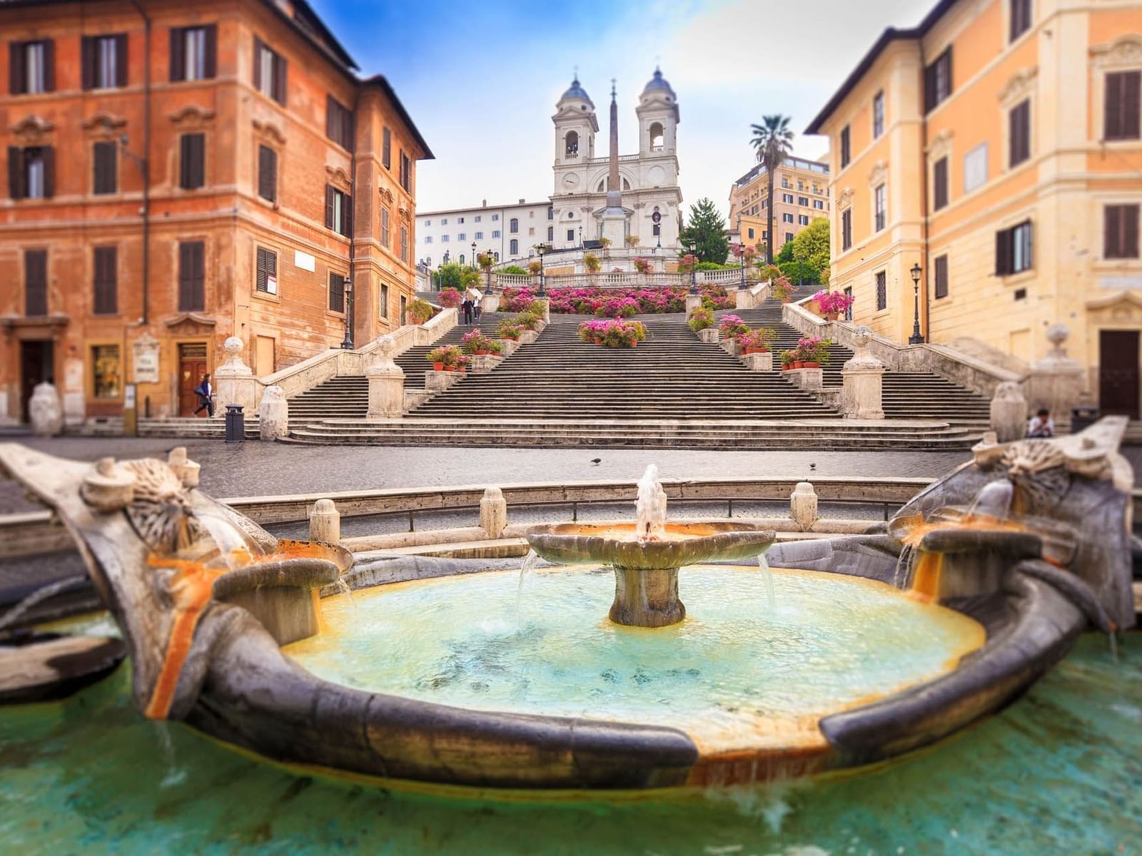 View of the Spanish Steps adorned with flowers, and a fountain near The Guardian Hotel
